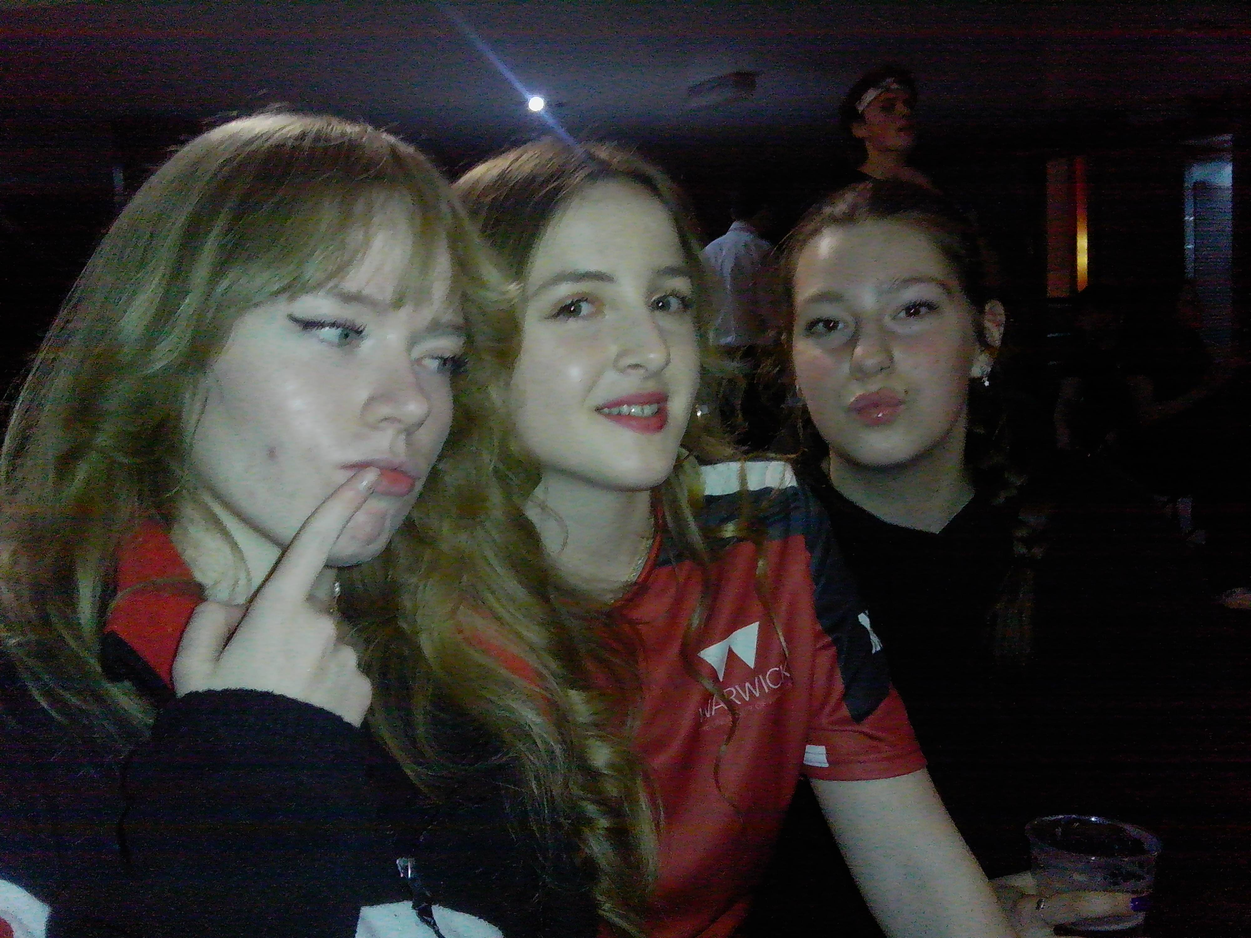 Three members posing for a photo on a night out